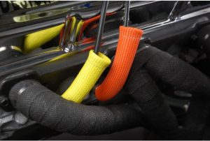 Protect-A-Boots are the latest in thermal protection technology for spark plug boot protectors. Developed from a unique material mined from lava rock, stranded and woven into a proprietary weave for added durability and strength, yet is pliable enough to provide a universal fit for straight or angled boots. Titanium Protect-A-Boots are naturally resistant to heat, chemicals, abrasions and contaminants, and are engineered to withstand temperatures up to 1800°F (983°C) of direct heat. High horsepower engine compartments are known for extreme heat that can put spark plug boots and wires at risk. With excessive heat generated from the exhaust manifold and headers the ignition system is vulnerable to the potential of burning, hardening and cracking of ignition wires and boots that could lead to arching, engine misfire and potential ignition system failure. Titanium Protect-A-Boots, with LR technology, are engineered to handle extreme heat, providing the ultimate protection for today's high voltage ignition systems for many applications including automotive, marine and powersports. The color and weave work together to give DEI's Titanium Protect-A-Boots a "cool" carbon fiber appearance that looks great under the hood – ideal for race, street, show cars and off road vehicles. Ultimate protection for spark plug boots & wires Withstands heat up to 1800°F (983°C). Our 6’’ Titanium Protect-A-Boots come with a reinforcement ring at the base for easy plug removal during maintenance. When working on boots with tight bends, try our 8’’ Titanium Protect-A-Boot XL Ringless instead. For thicker boots, like MSD or Taylor’s, we recommend our Protect-A-Boot Ringless Sleeves; the 1.25’’ diameter will allow for a simple install. Ultimate protection for spark plug boots & wires Non-flammable & protects against chemicals & resists water Double-wall construction for added durability Cool carbon fiber look Boots measure 6" L 2 boots per pack Reinforcement ring at the base for easy plug removal during maintenance Length: 6 inch ID: 1 inch Pack: 2-Pack Boot Angle: Straight