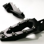 Designed specifically for the Indian Motorcycle, these foot pegs have the style your bike deserves. They are not just another clunky billet foot peg the design rates very high on our list of priorities and it shows with these foot pegs and their arrowhead accents. Made of lightweight billet aluminum these are likely the only foot pegs you can buy for you Indian Motorcycle that include a spring to push the foot peg down, where it belongs. Designed to be thinner at the end, they can allow you to get lower in the corners when you are carving through the twisties. The stainless steel cleats give your foot grip that far exceeds other foot pegs, especially when you get caught out in that rain storm.