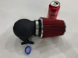 The filter comes with a silicon band to seal the airbox to the intake manifold. The coke can is not included but helps illustrate the size.
