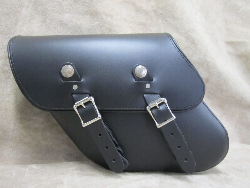 SCOUT BOBBER SADDLEBAGS / PANNIER BAGS WITH MOUNTING KIT These Leather saddlebags - 11" x 4 ½" x 11" (L" x W" x H") - is designed for Indian Scout Bobber. It will fit the 2018+ Scout Bobber, 2020+ Scout Bobber Sixty and 2019+ Scout Bobber Twenty motorcycles, allowing the turn signals to remain in stock location. The bags come with a hardware needed to permanently mount the bags to the fender. The hardware will not work with a detachable backrest. All of our saddlebags feature quick-release clips behind stainless roller bar buckles for easy opening and closing. These saddlebags are a timeless classic and feature our trademark Indian Head Nickels. Indian Head Nickels serve as your proof of authenticity and are distinctive on all of our leather bags. CUSTOM MOTORCYCLE LEATHER SADDLEBAGS Made from 10 oz US-sourced leather, our bags will hold up to years of use on your favorite bike. Handling our own leather from beginning to end makes it easy for us to customize the process along the way according to what our customers are looking for! SADDLEBAG FITMENT These leather saddlebags will fit the Indian Scout Bobber, 2020+ Scout Bobber Sixty and 2020+ Scout Bobber Twenty. The hardware will not work detachable backrests or luggage racks. Proudly MADE IN THE USA. High-Quality 10 oz leather means you get a lot more long-term value out of your motorcycle pannier bags ABS Plastic reinforced and rubber-backed to prevent sagging and ensure a secure fit to bike. Every single stress point is hand riveted and sewn with industrial strength nylon, making our bags the toughest on the market Quick-release access buckles mean decreased wear and easy cinching. Our Water-resistant treatment helps protect your bag and valuables. Comes with all the mounting gear you need. HIGH-QUALITY AMERICAN LEATHER In addition to being handcrafted right here in the US, all of our leather is produced right here in America as well. All cows are raised in Texas, tanned in Milwaukee, and then finally we use that leather in our Stockton, CA workshop. Fully American. The leather is treated at the tannery to be both UV and water-resistant. This means no fading leather or swelling bags after a rain.