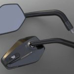Available versions: Left-hand and Right-hand. The surface of the housing is made of CNC 3D machined aluminum, The mirror is made of a tinted convex glass (reduces dazzling). Integrated in the housing: Exchangeable impact protector made of black plastic. This item prevents the mirror housing against ugly scratches caused by bumping on the house or garage wall when parking the bike, for instance. The 'arm' of the mirror is elbowed twice. This enables for more movement and super three-dimensional optics. The mirror can be adjusted utilizing a solid ball clamp made of high-grade stainless steel. All Black anodized.